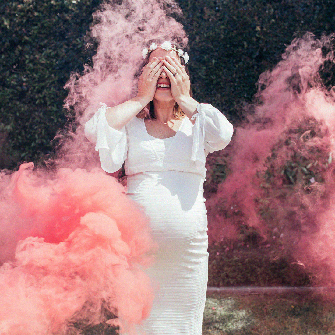 Femme enceinte entourée de fumée rose